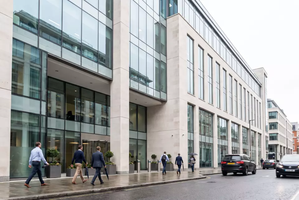 A modern office building with a glass and stone facade