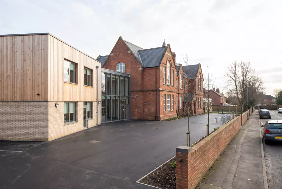A secondary school with a newer teaching block beside an older Victorian building